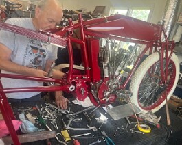 Newly painted gas tank is fitted to the frame